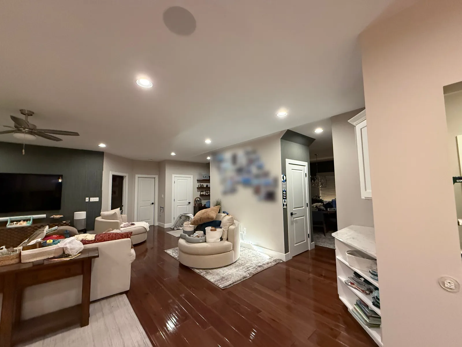 Furnished living space with light painted walls, a dark accent wall, white ceiling and white door trim